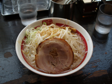 Bowl of Ramen with bean sprouts and a slice of pork